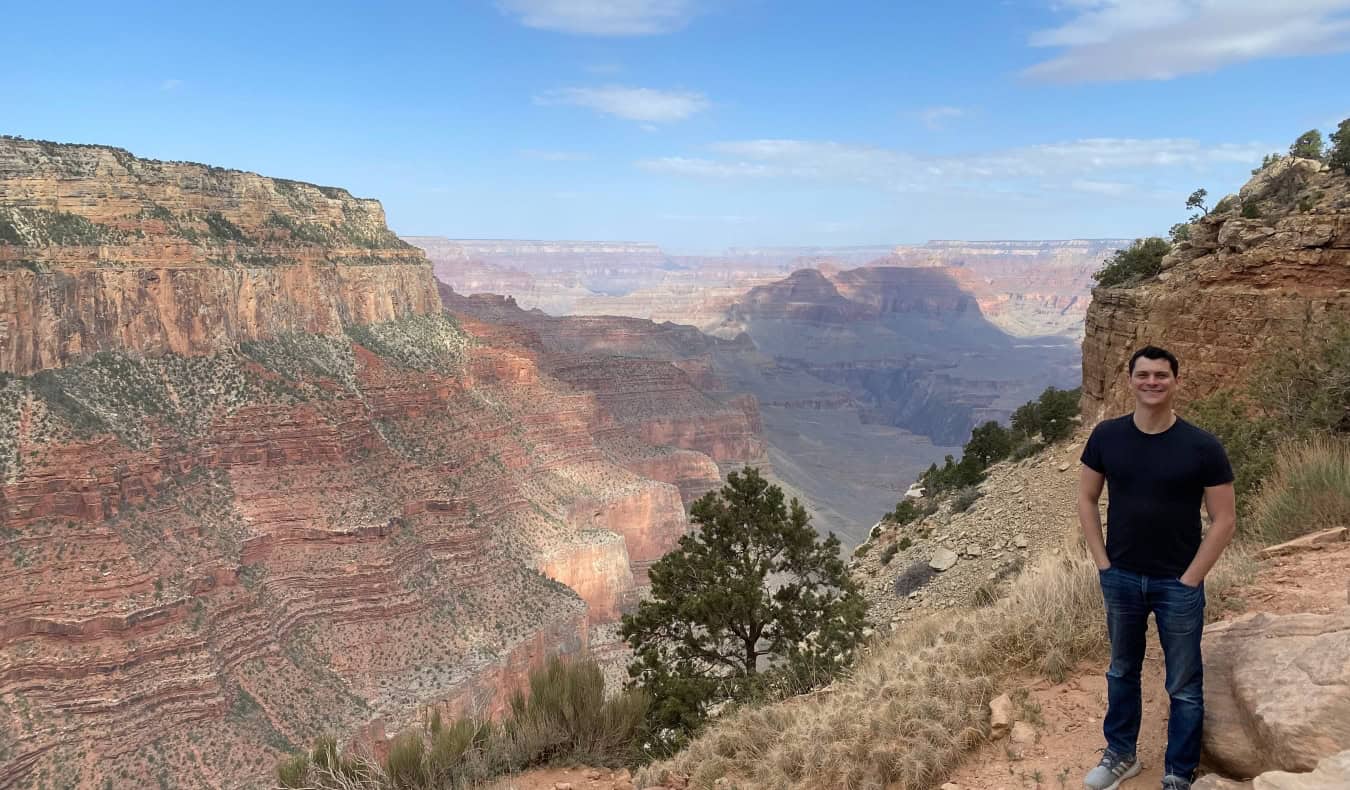 Nomadic Matt posing for a photo in front of the Grand Canyon