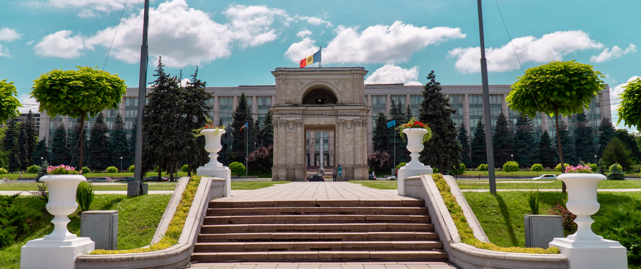 A historic building in the capital city of Chisinau on a bright summer day with the flag waving