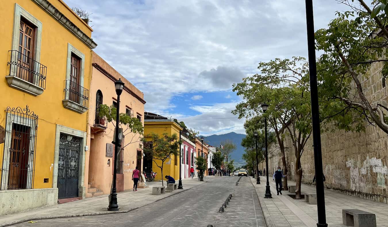 The colorful streets of Oaxaca, Mexico on a bright and sunny day with people out walking